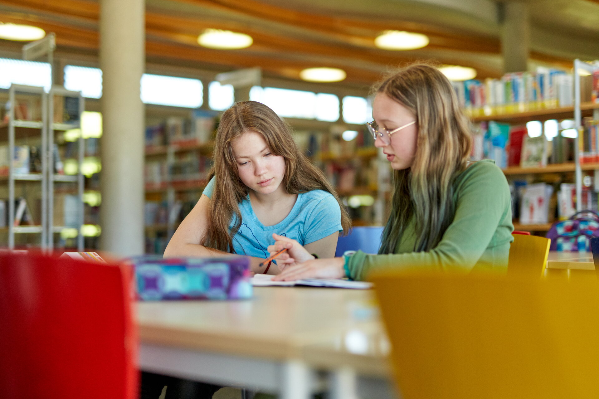 Schülerinnen beim Lernen in der Schulbibliothek